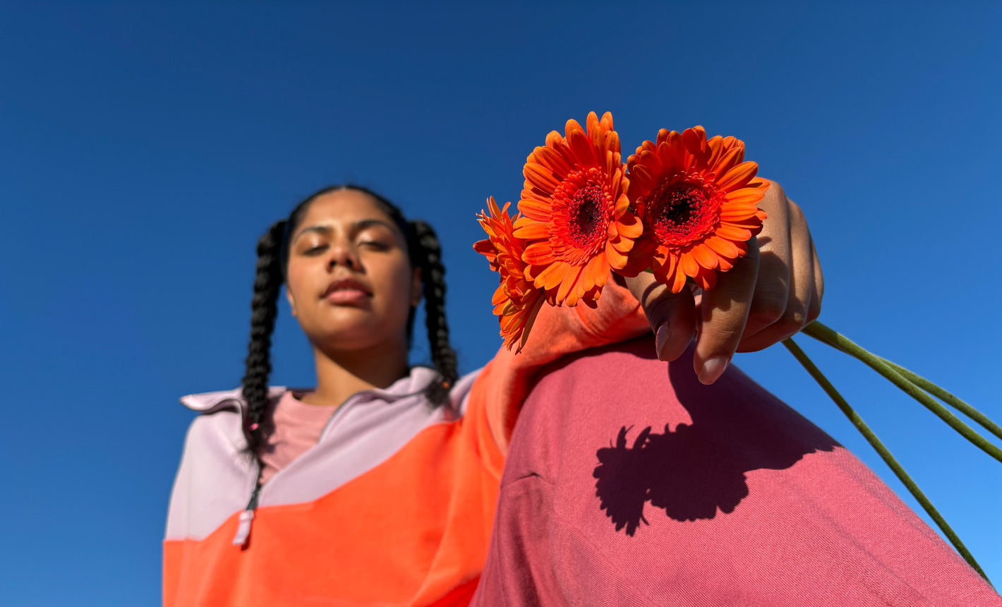 Zdjęcie portretowe przedstawiające kobietę trzymającą kwiaty