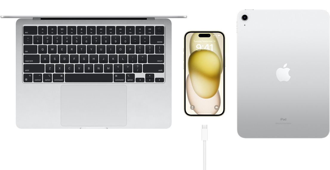 Bovenaanzicht van MacBook Pro, iPhone 15 met een USB-C-connector en iPad