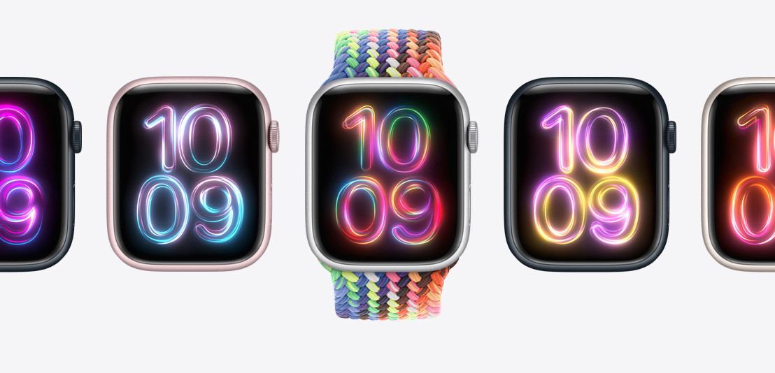 複数のApple Watch Series 9。中央のApple Watchには新しいネオンマルチカラーのプライドエディションブレイデッドソロループが組み合わせられ、それぞれのApple Watchに異なるカラーのプライドラディアンス文字盤が表示されている。