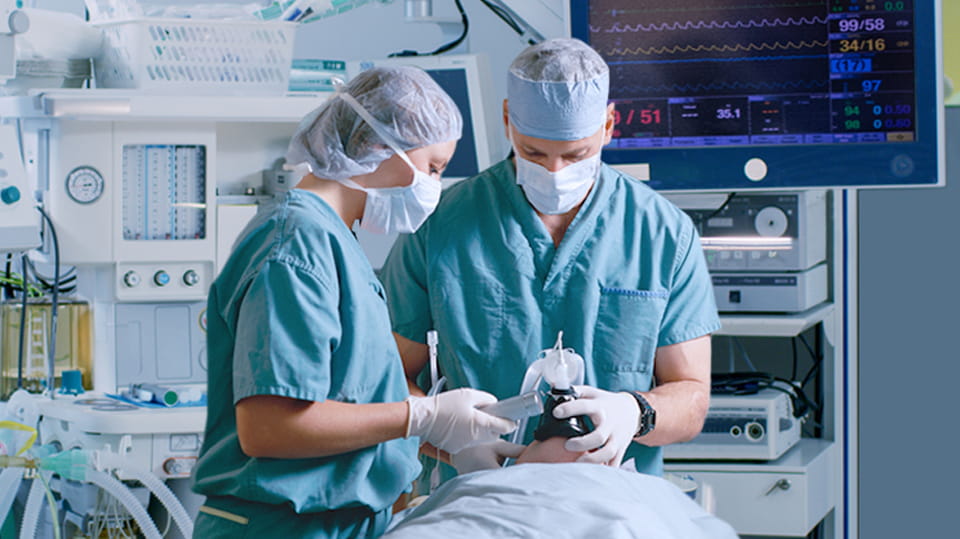 Physician-led care team administering and monitoring anesthesia in an operating room