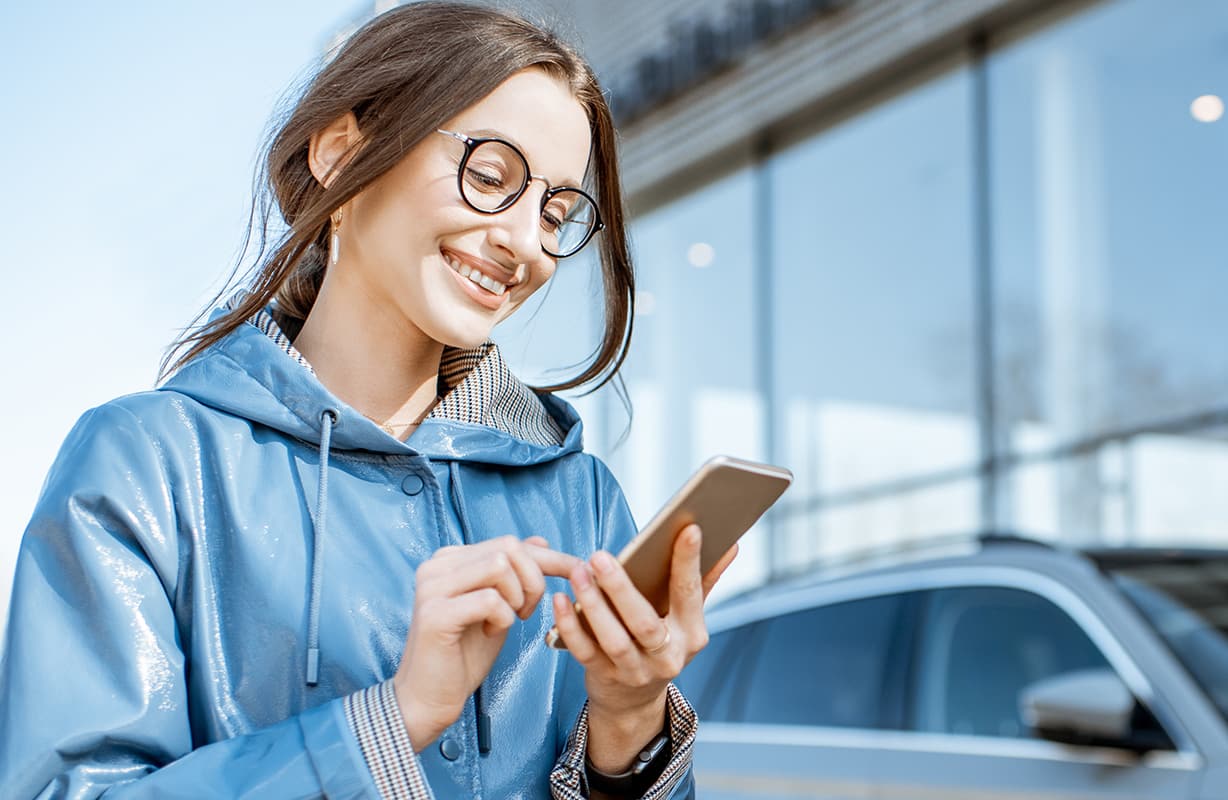 girl looking at her phone and smiling