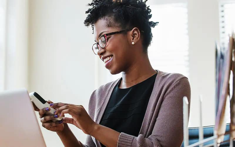 woman holding the phone and smiling