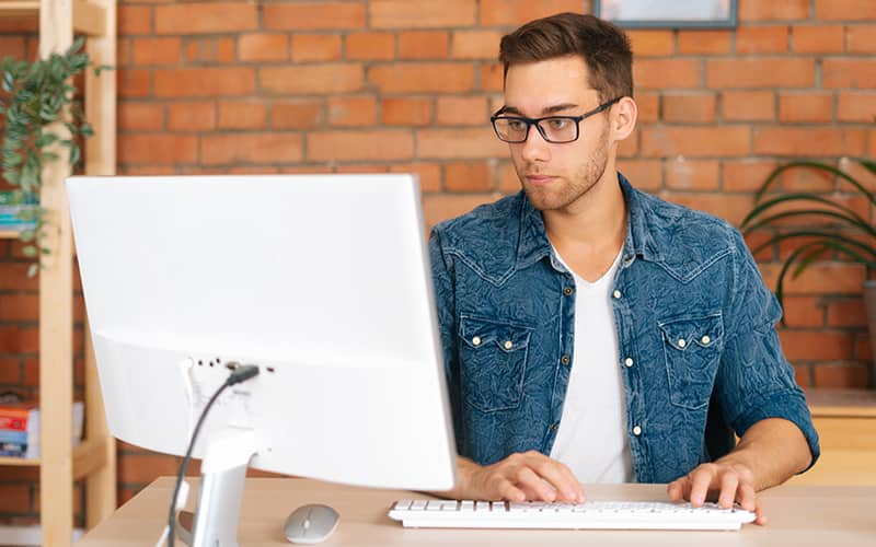 a man looking at his dasktop