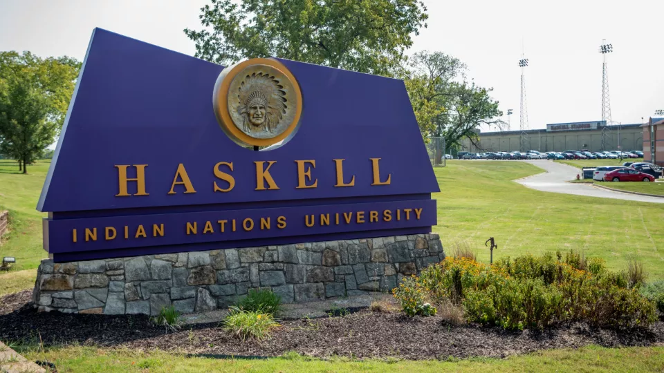 Large purple sign with Haskell Indian Nations University in yellow.