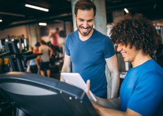 Personal trainer with a client at the gym.