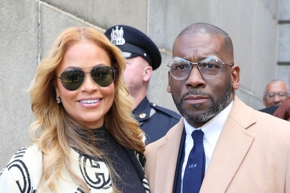 Gizelle Bryant and Jamal Bryant posing together outdoors at an event.