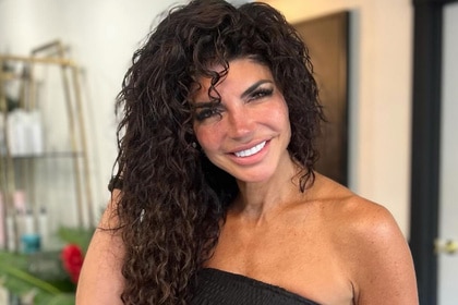 Teresa Giudice smiling inside of a hair salon.