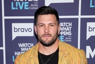 Brock Davies standing in front of a step and repeat at the Watch What Happens Live clubhouse in New York City.