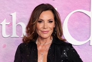 Luann De Lesseps posing in front of a step and repeat.