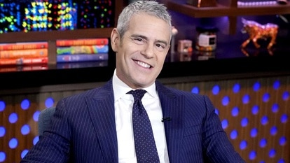 Andy Cohen smiles at the camera on the set of Watch What Happens Live