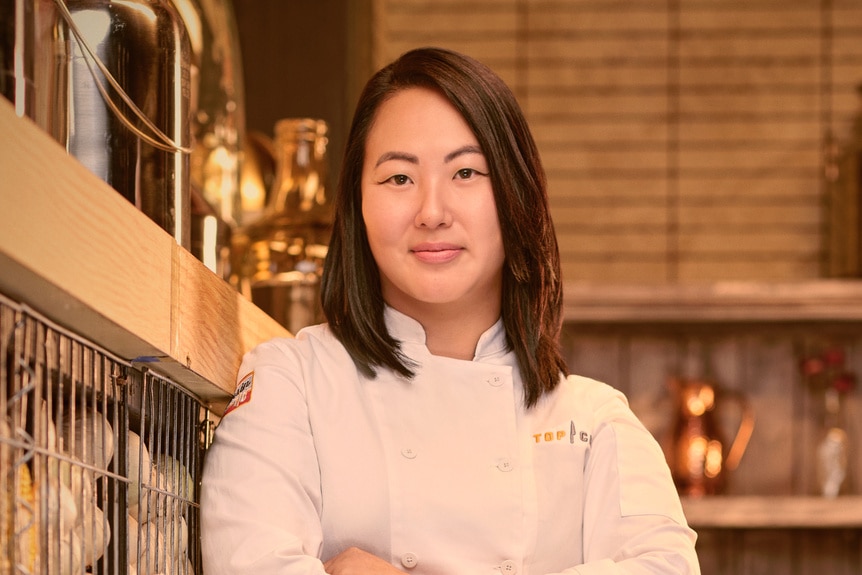 Kaleena Bliss wearing a chef's uniform in a kitchen pantry