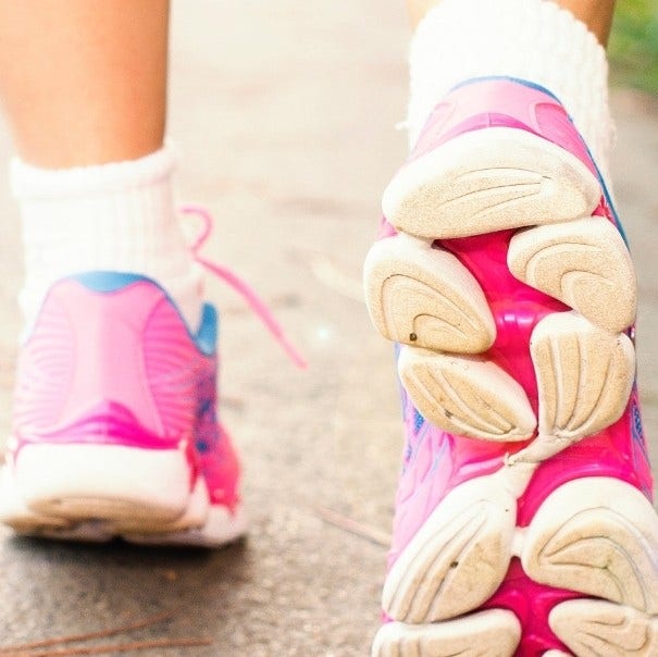 close up of feet in fitness shoes walking on street