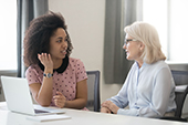 2 women talking in office