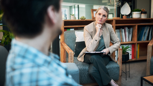 Shot of a mature woman having a therapeutic session with her patient.