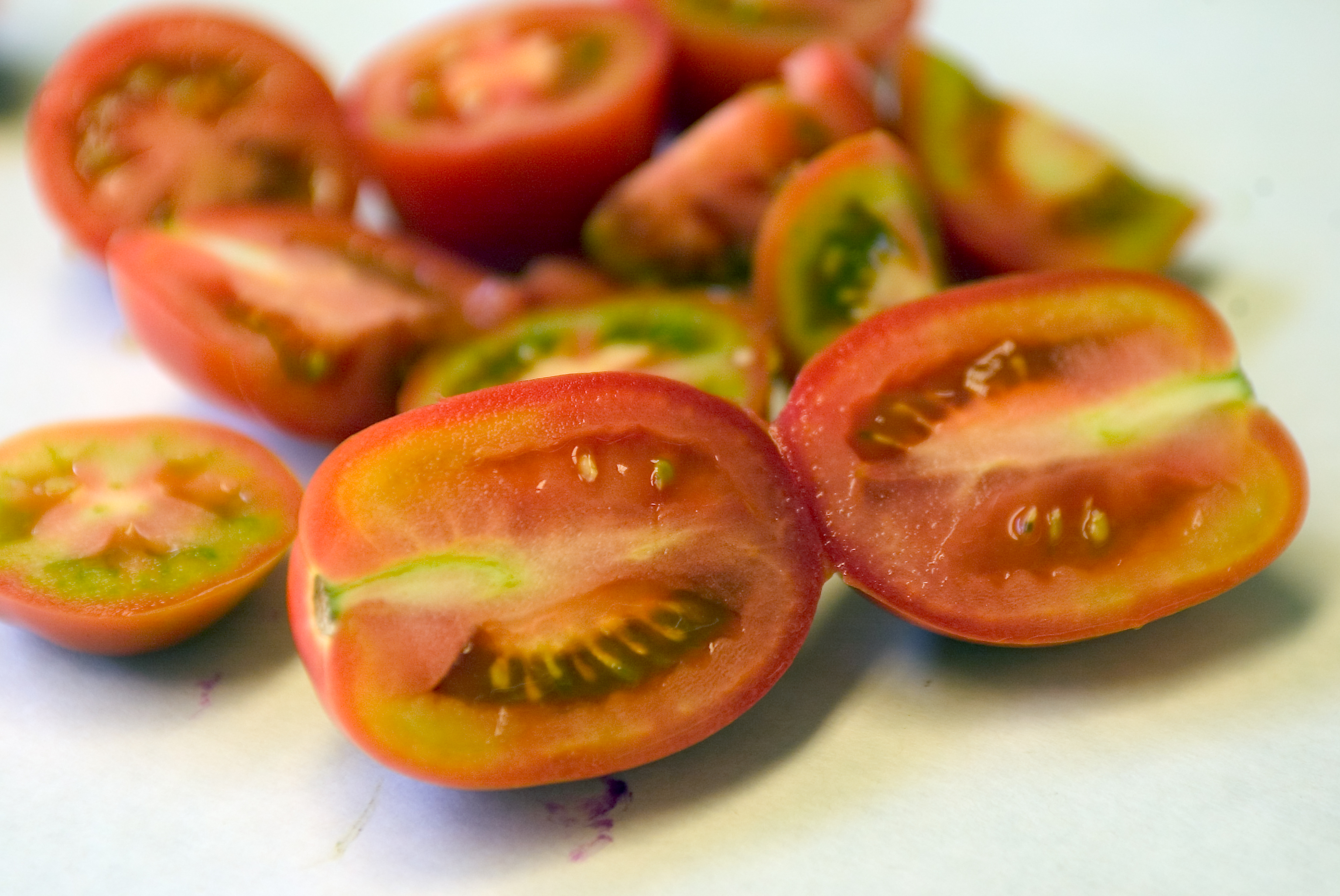 Agriculture Specialists check inside cherry tomatoes coming into the Port of Long Beach for potential pests.