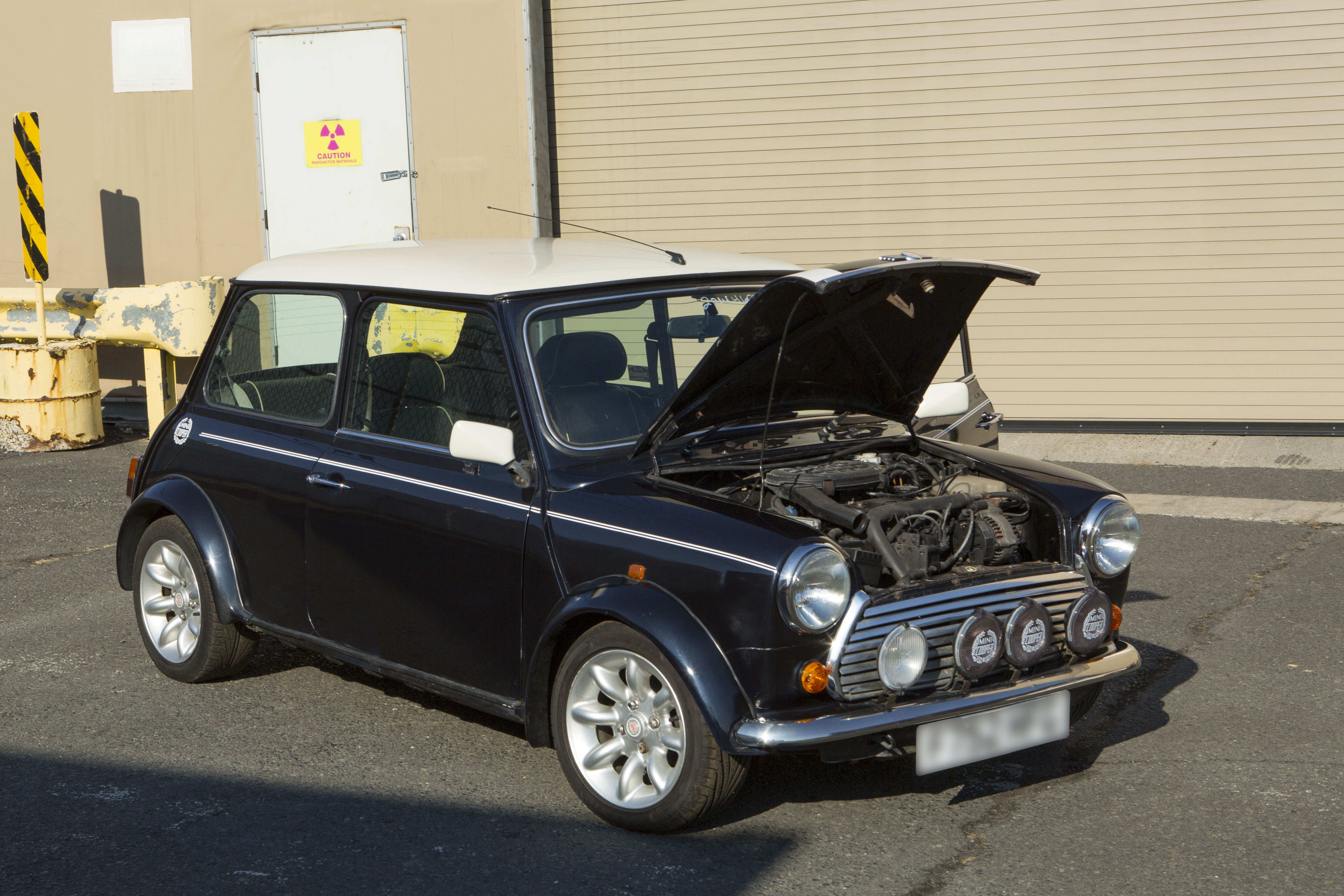 A Customs and Border Protection Officer inspects a Mini Cooper that arrived to Port Elizabeth NJ that had numerous violations associated with it related to importation. This vehicle will be destroyed as a result. Photo Credit: James Tourtellotte