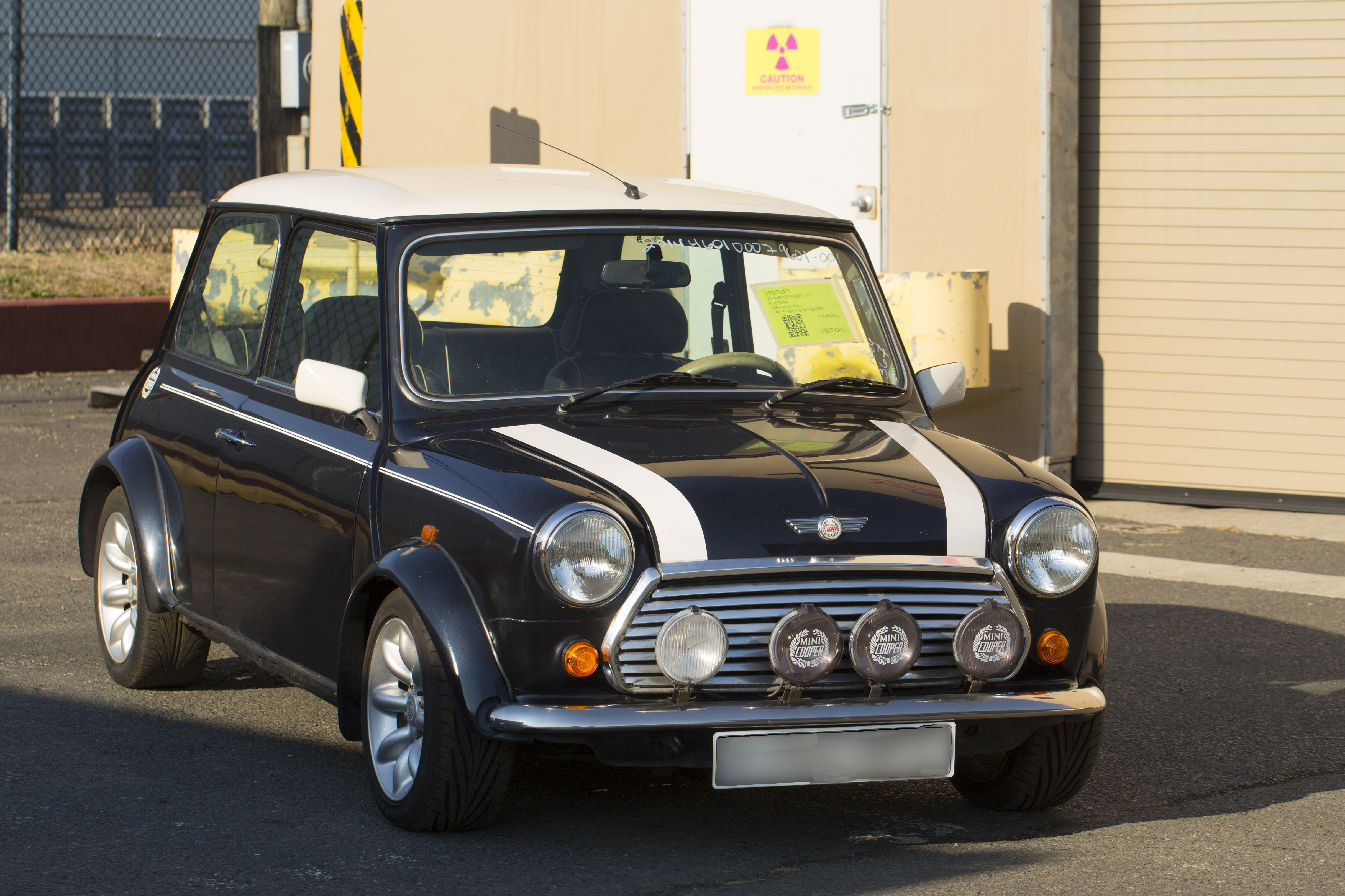 A Customs and Border Protection Officer inspects a Mini Cooper that arrived to Port Elizabeth NJ that had numerous violations associated with it related to importation. This vehicle will be destroyed as a result. Photo Credit: James Tourtellotte