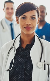 Close up of a group of doctors with a woman doctor in the front