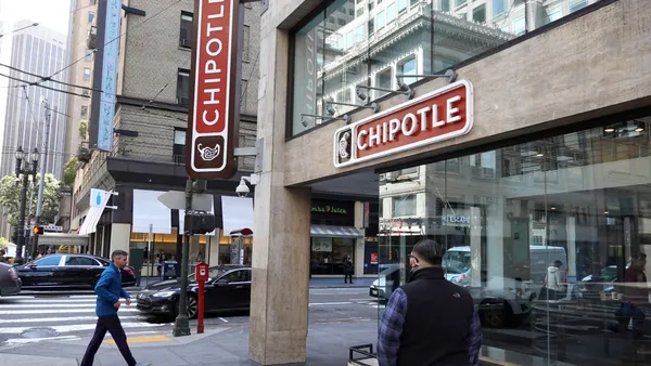 Pedestrians walk by a Chipotle restaurant in San Francisco, California