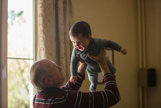 grandfather holding baby