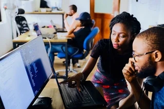 two people working on a computer