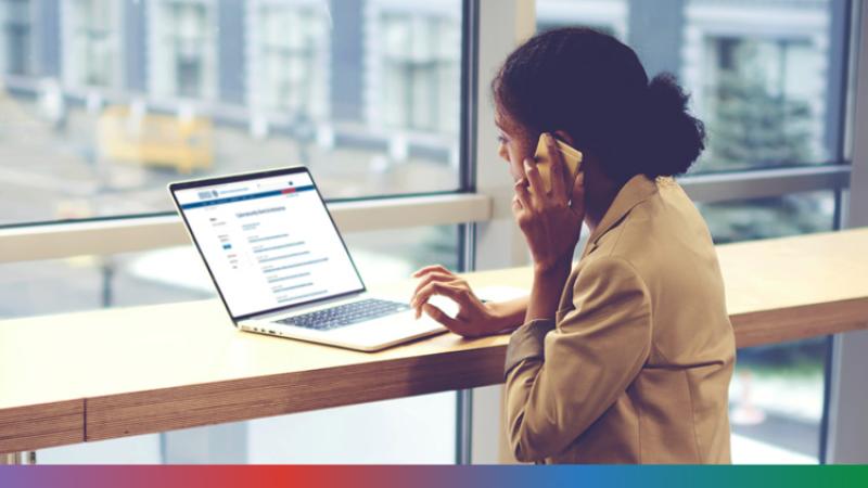 Woman looking at a laptop on the phone