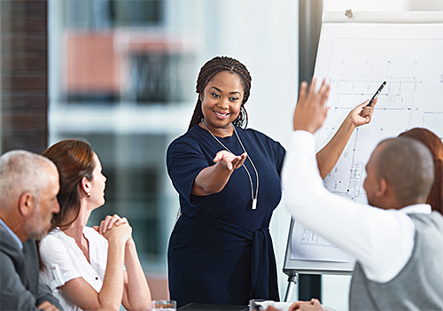 Person presenting to a group of people.