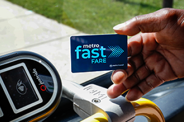 handing holding a Fast Fare card