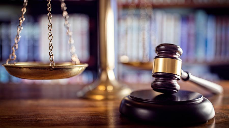 Gavel and scales on desk