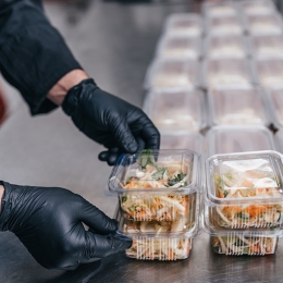 Food in disposable dishes ready for delivery. The chef prepares food in the restaurant and packs it in disposable lunch boxes.