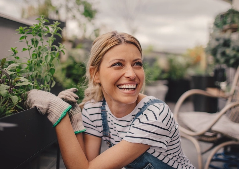 woman-smiling-and-gardening-767x544.webp