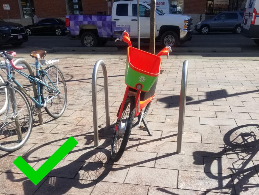 An example of correct parking - park next to or locked to bike racks when possible is parked upright.
