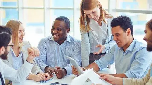 Employees in a group talking to one another