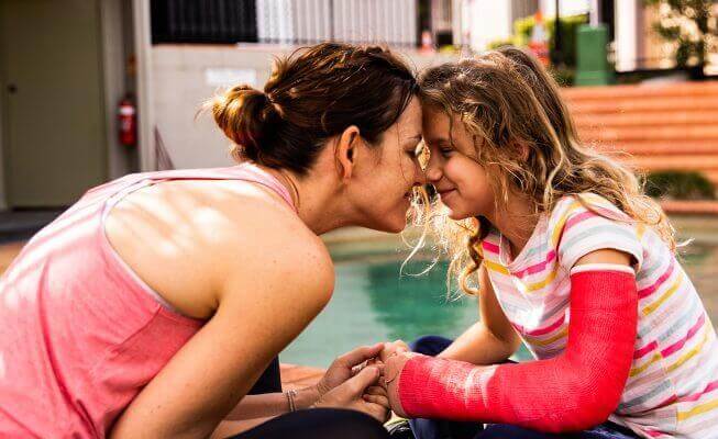 Mother considers an online savings account while spending time with her young daughter.