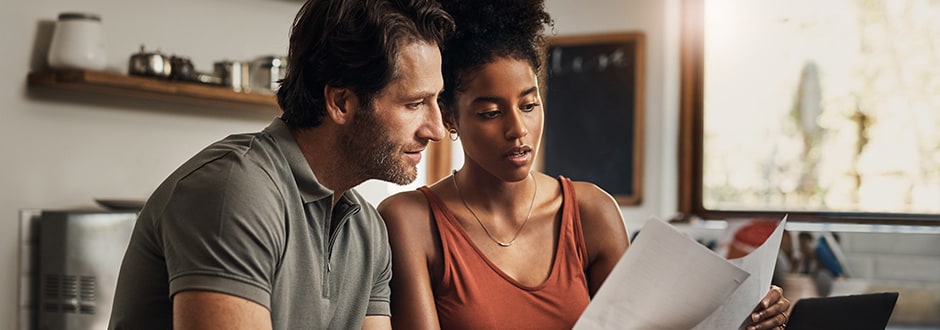 Young couple at table reviewing their home equity loan rates, terms, and repayment details