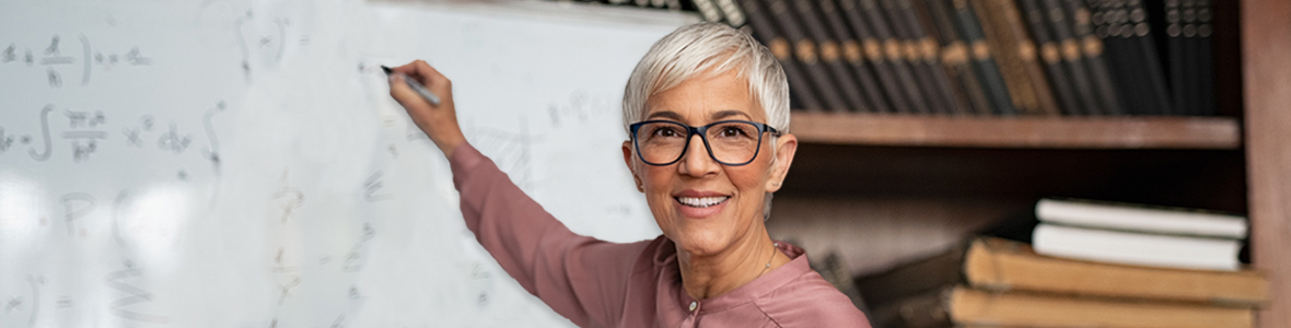 Female professor standing in front of a whiteboard