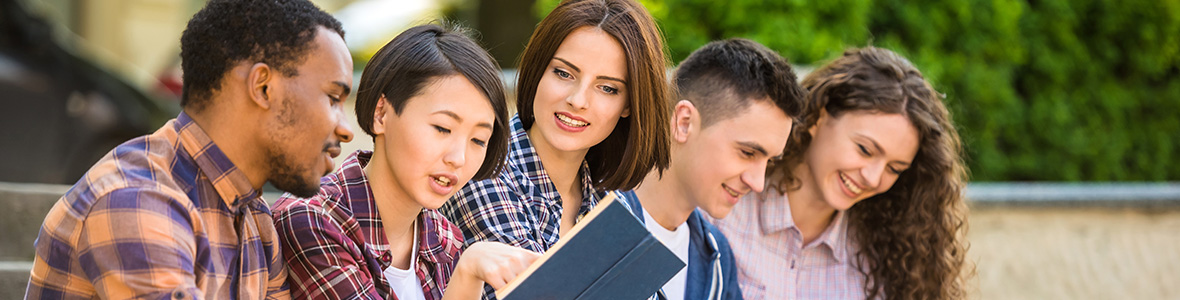 Five students studying on the steps of the university