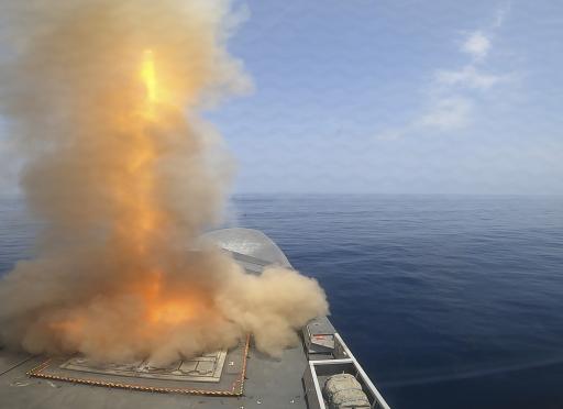 Missile launch plume from bow of a ship.