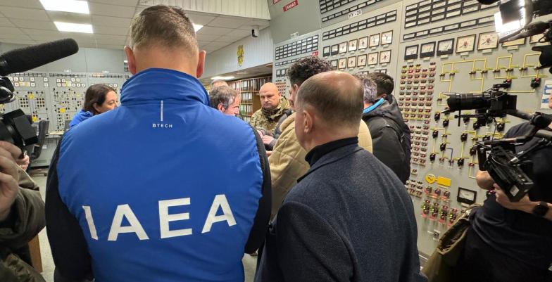 Official crowd a control room in a nuclear power plant.