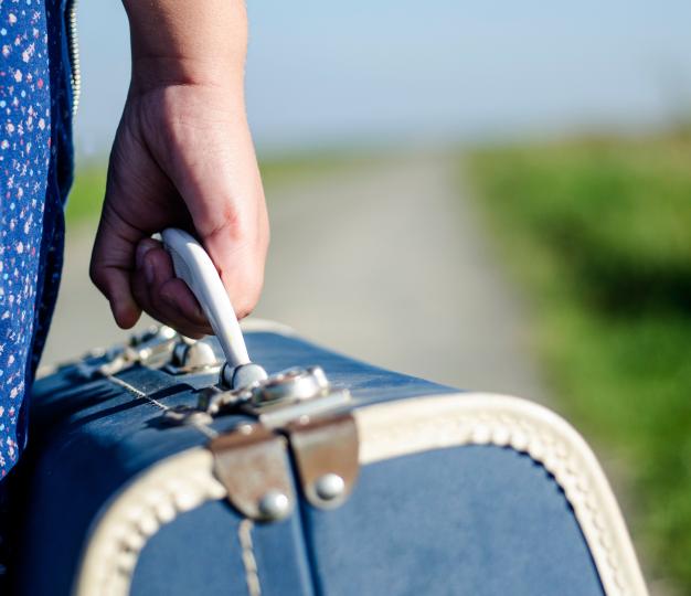 Person holding suitcase