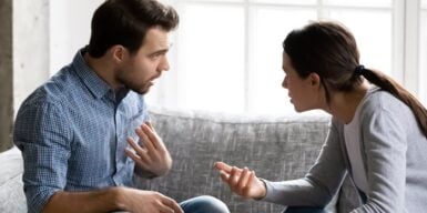 A couple having a heated argument on their couch