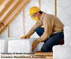 man installing insulation