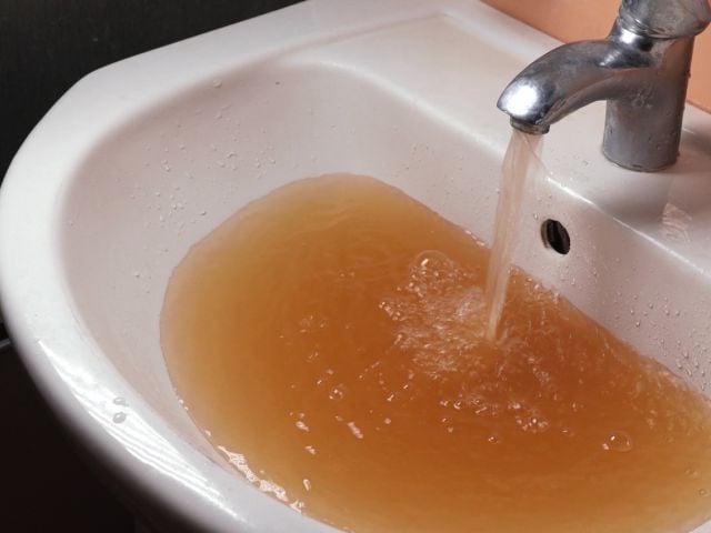 Brown tap water in sink