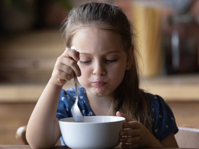 Young girl eating cereal