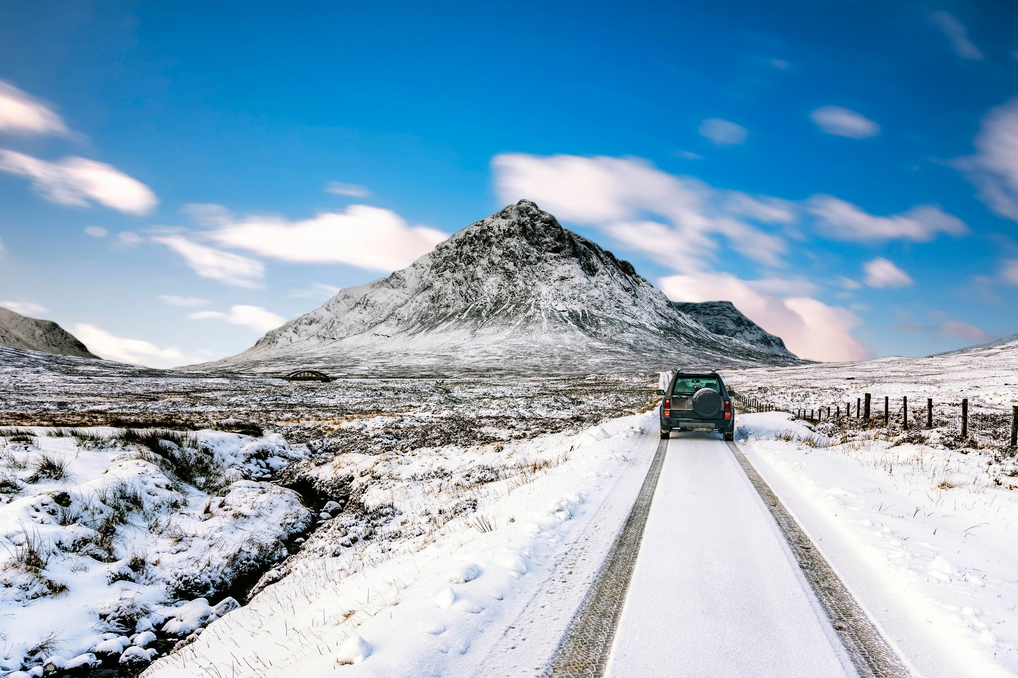 Four wheel drive vehicle with Buachaille Etive Mor, Glencoe, Scotland, UK