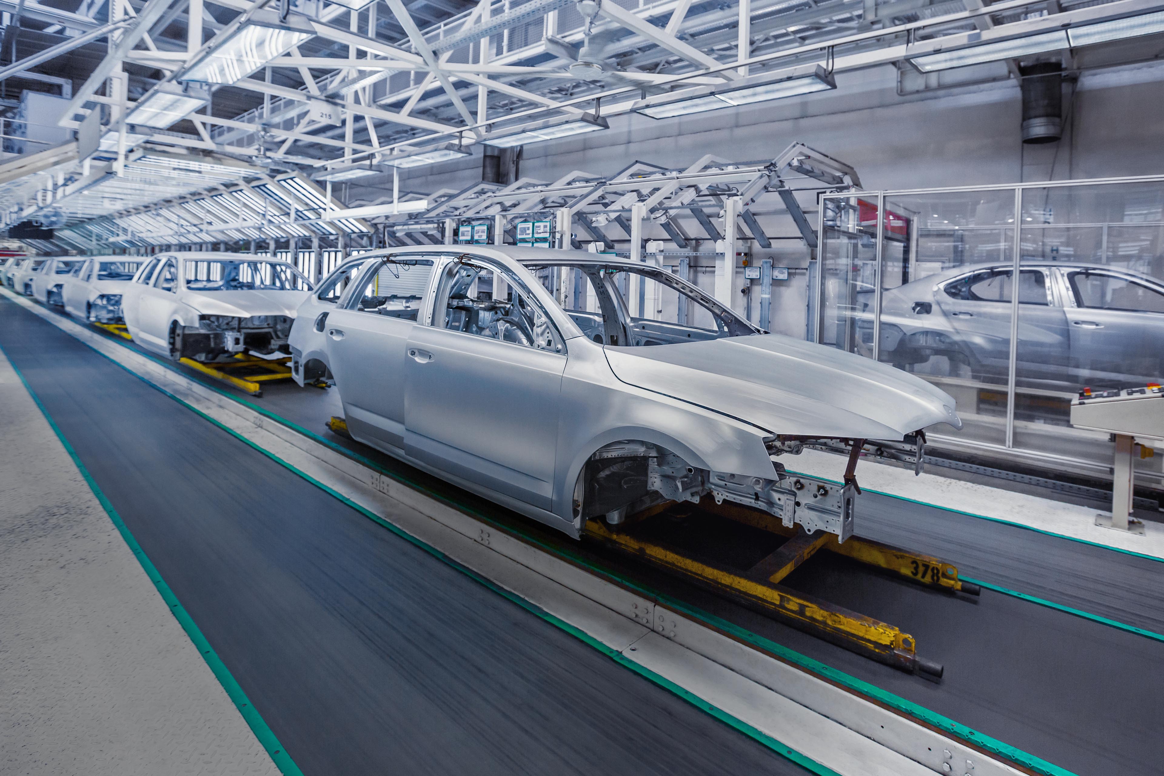 Prepared chassis in a row at car plant