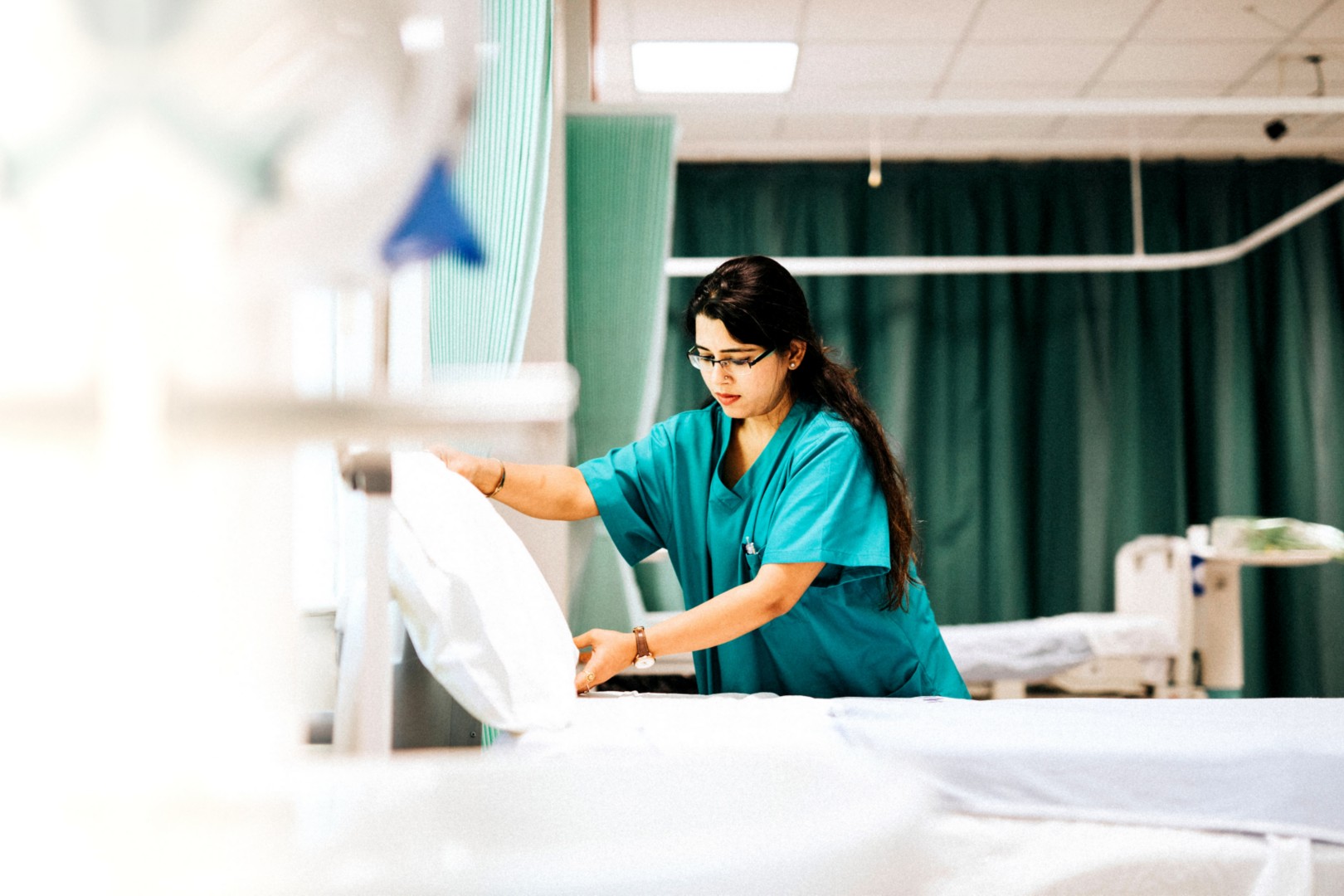 Nurse making the bed at a hospital