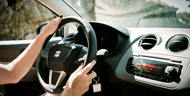 Girl's hands on a steering wheel