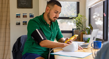 person at home using a virtual blood pressure machine