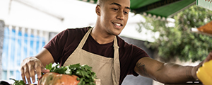 young man working at a produce market